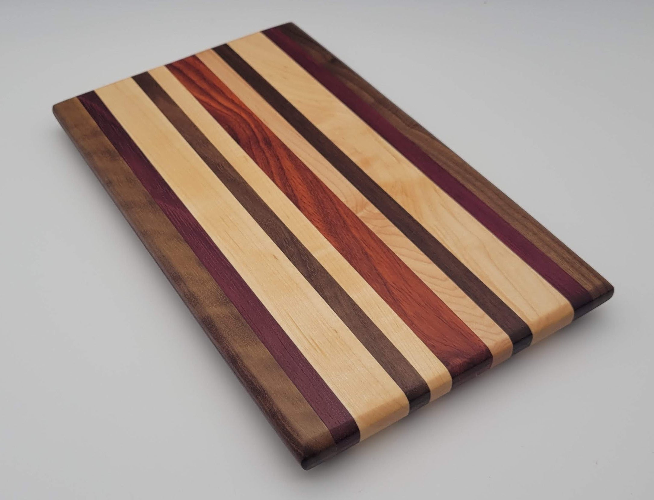 Cutting board = Walnut, purpleheart, maple, and paduak